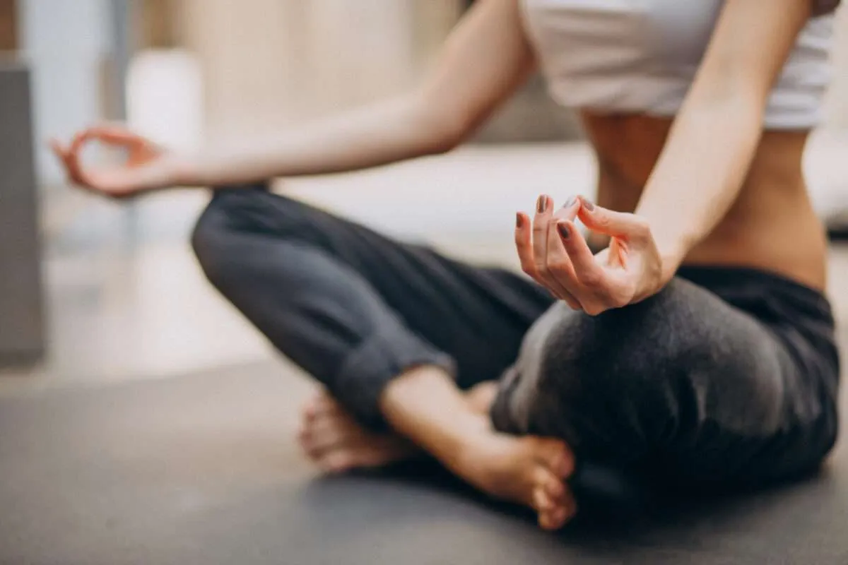 Person practicing mindful wellness outdoors